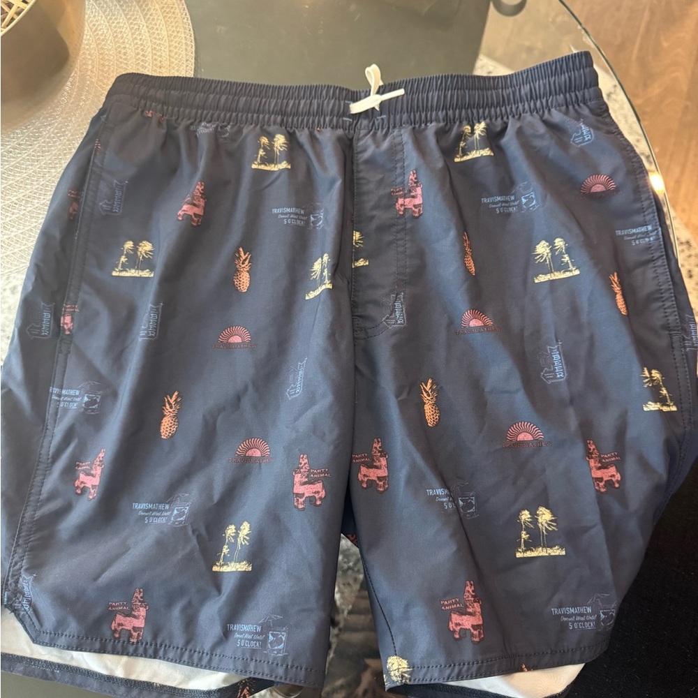 Travis Mathew Navy Swim Shorts with Red and Yellow Tropical Prints